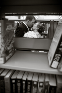 bride and groom kiss through books at library durango co portrait