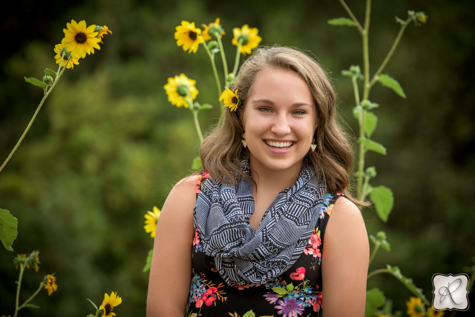 Jade's senior pictures Bayfield Colorado - smiling with sunflowers