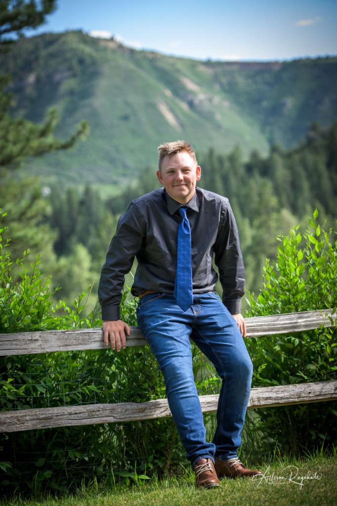 Guy on fence, Senior Portraits of Christian Swan in Durango