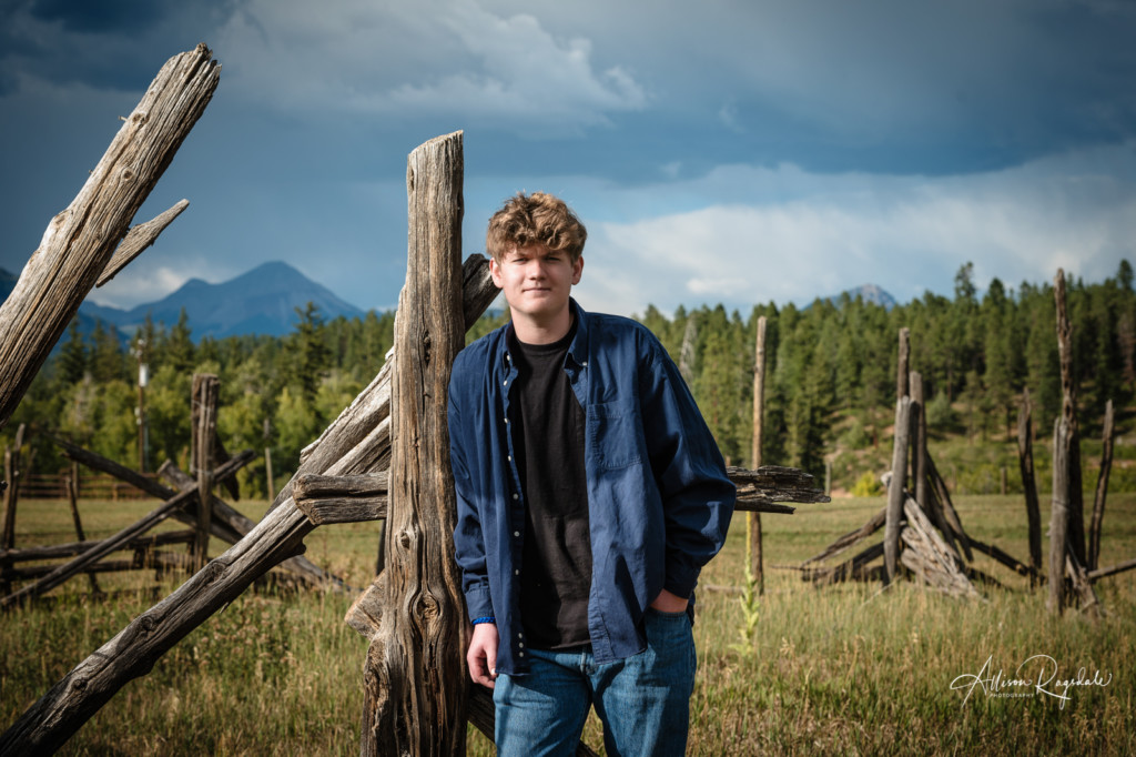 dramatic clouds engineer mountain background senior portrait