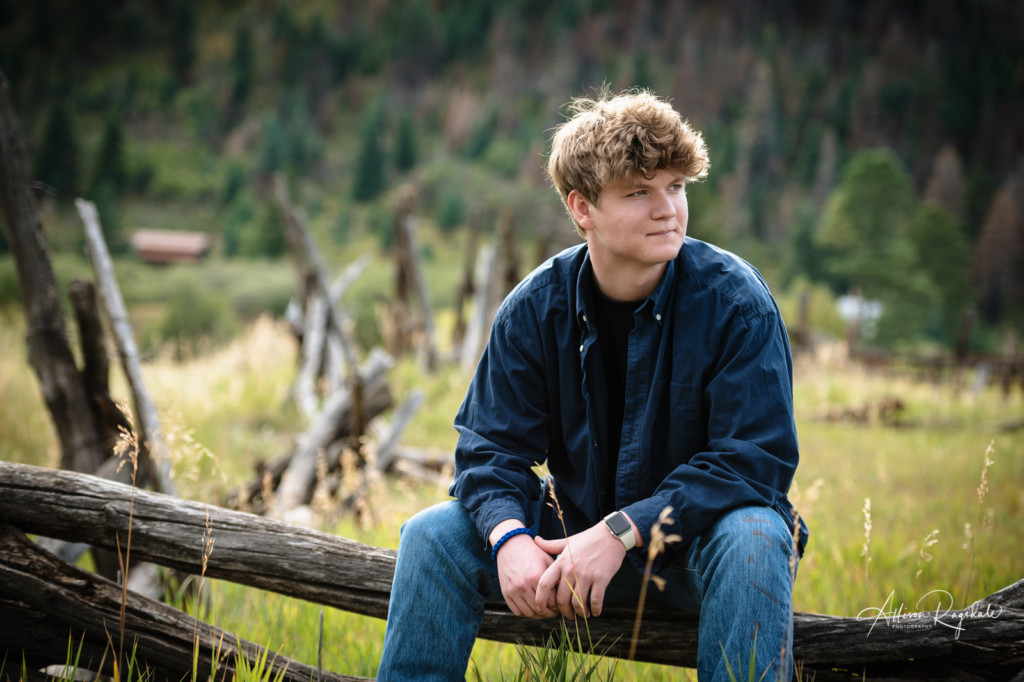 senior guy portrait rustic wood fence