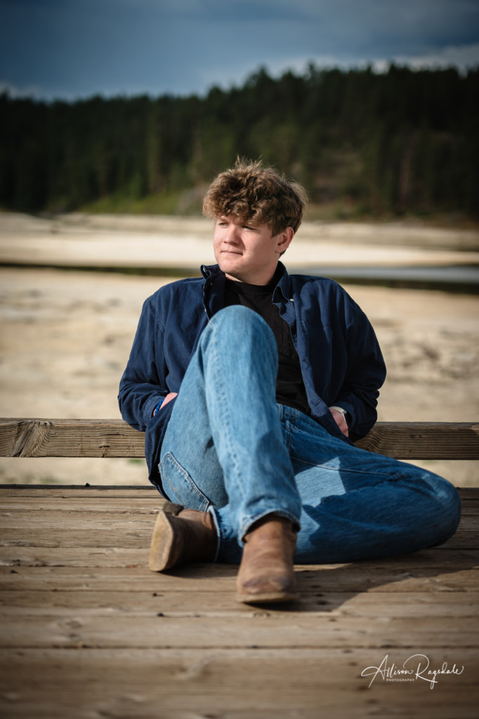 senior guy photos on dock with dry haviland lake bed in background