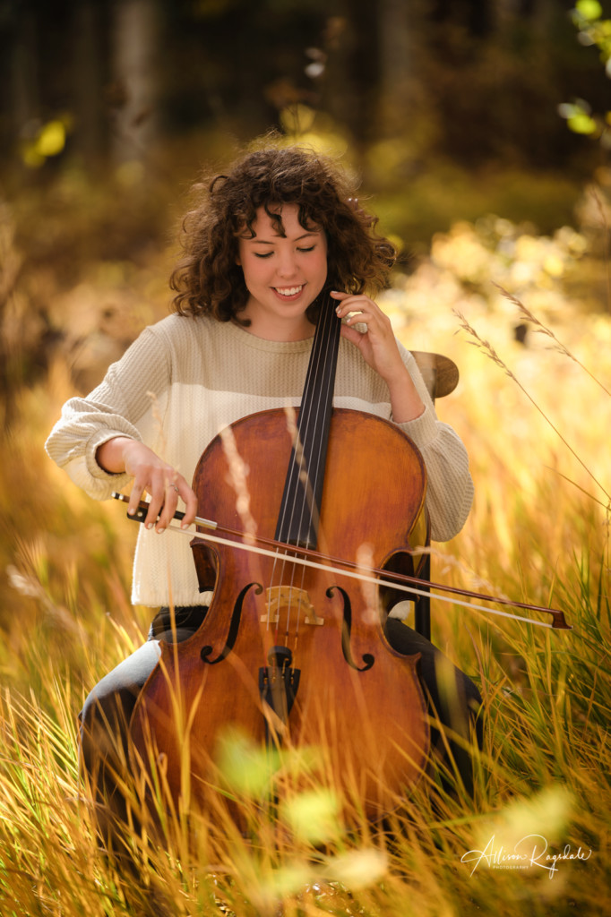 senior girl picture playing cello in long fall grass