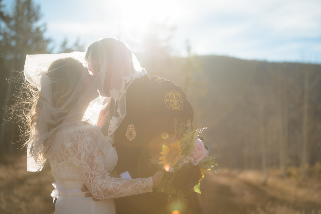 sunflare bride and groom under veil picture