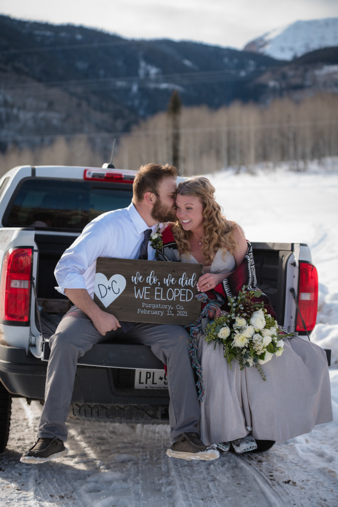 photo in back of truck elopement couple