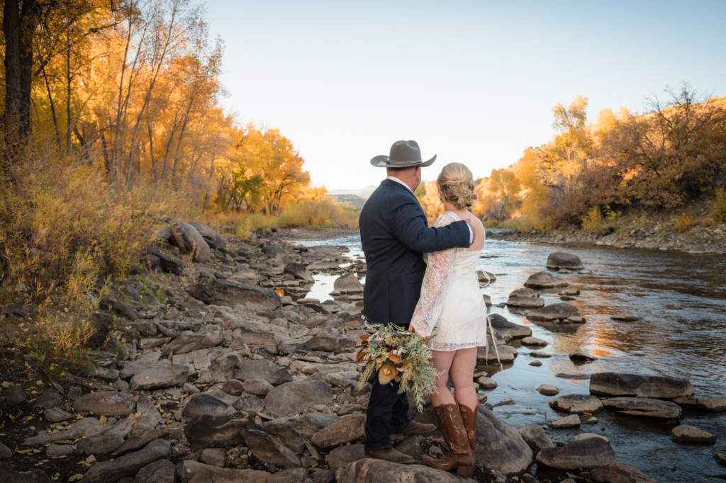 bride and groom looking at animas river durango fall season photo