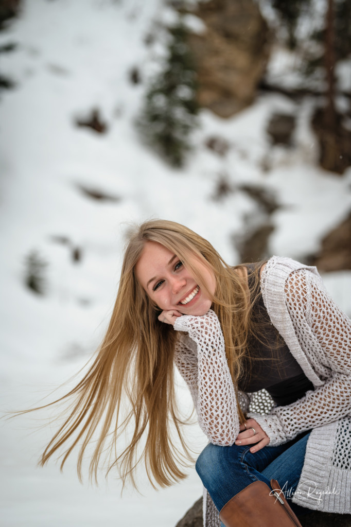 senior girl in snow hair blowing in wind picture