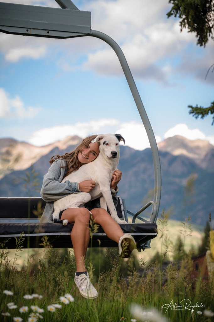 senior girl pic with her dog on chairlift at Purgatory resort