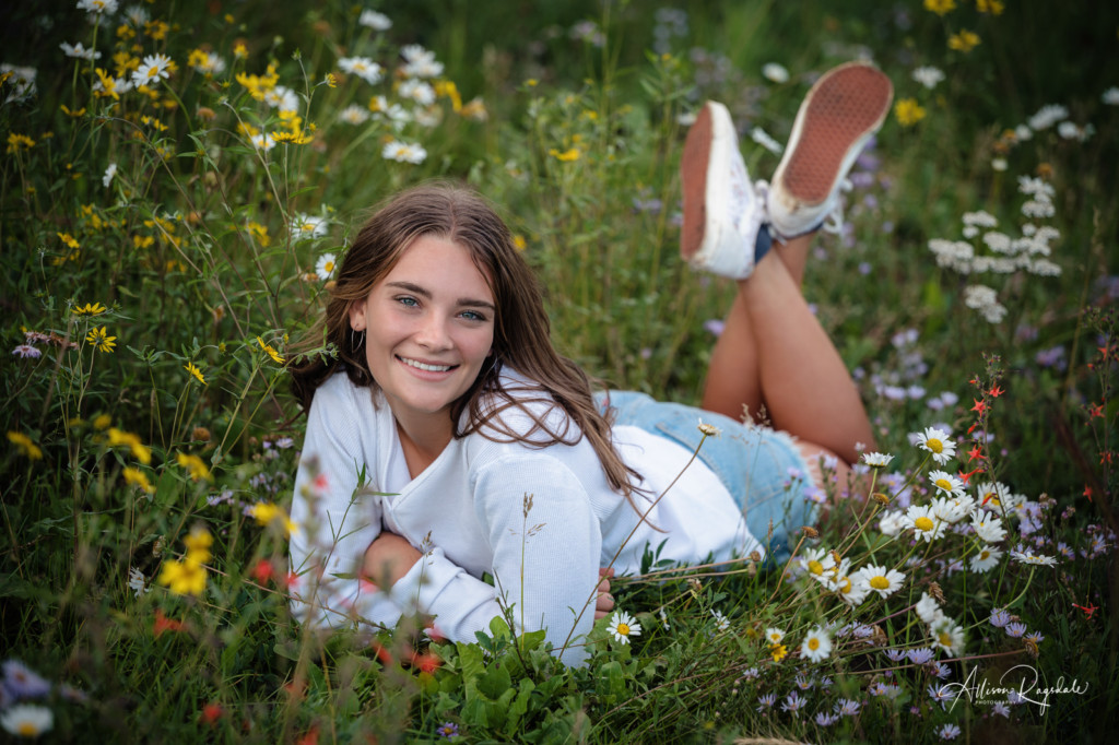 senior girl photo laying in wildflowers durango colorado