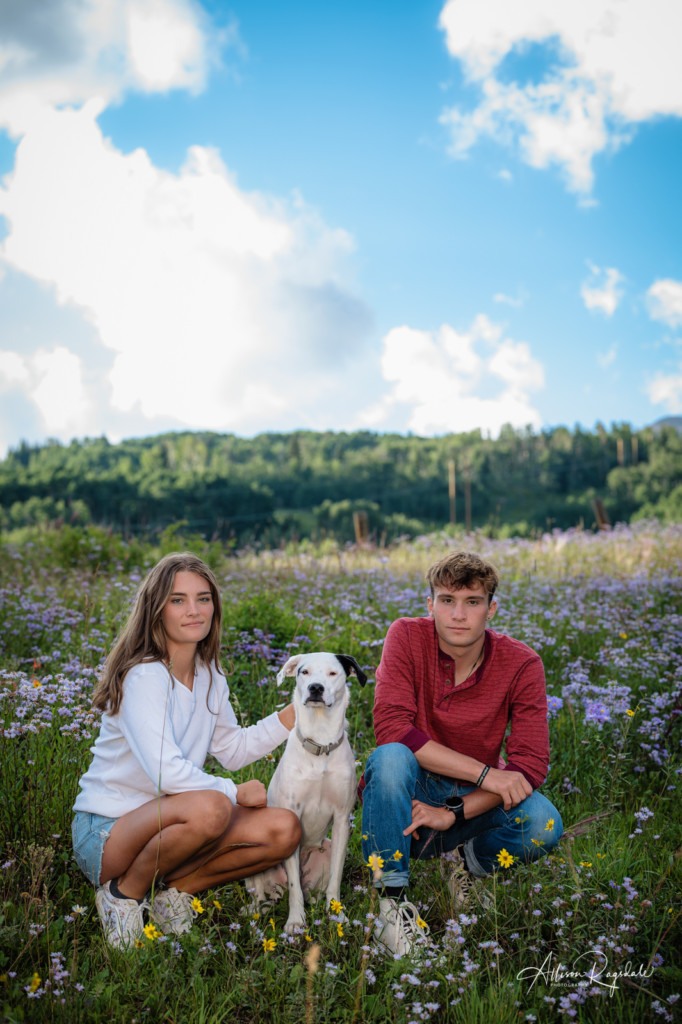 sibling picture with dog serious faces in wildflowers