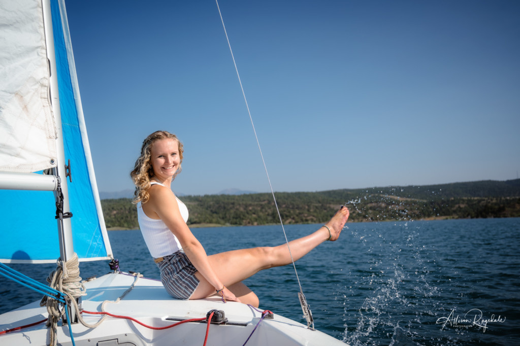 girl splashing on boat lake nighthorse senior pic