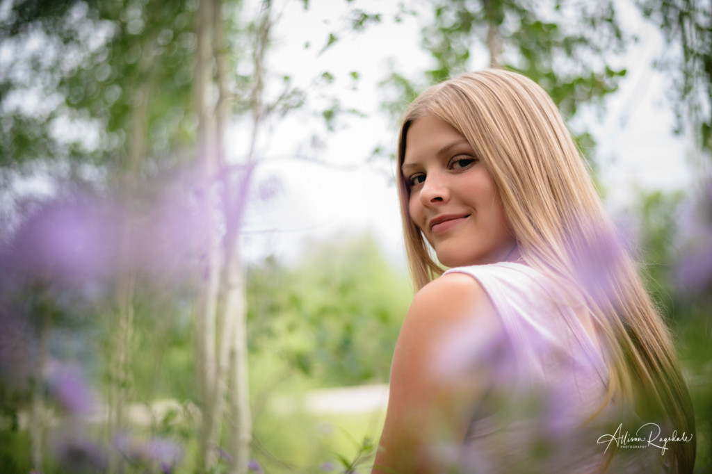 senior girl photo through purple daisies