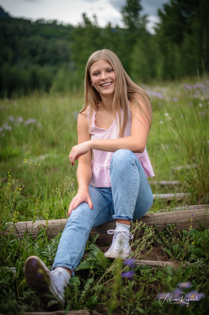 girl sitting on fence senior pic