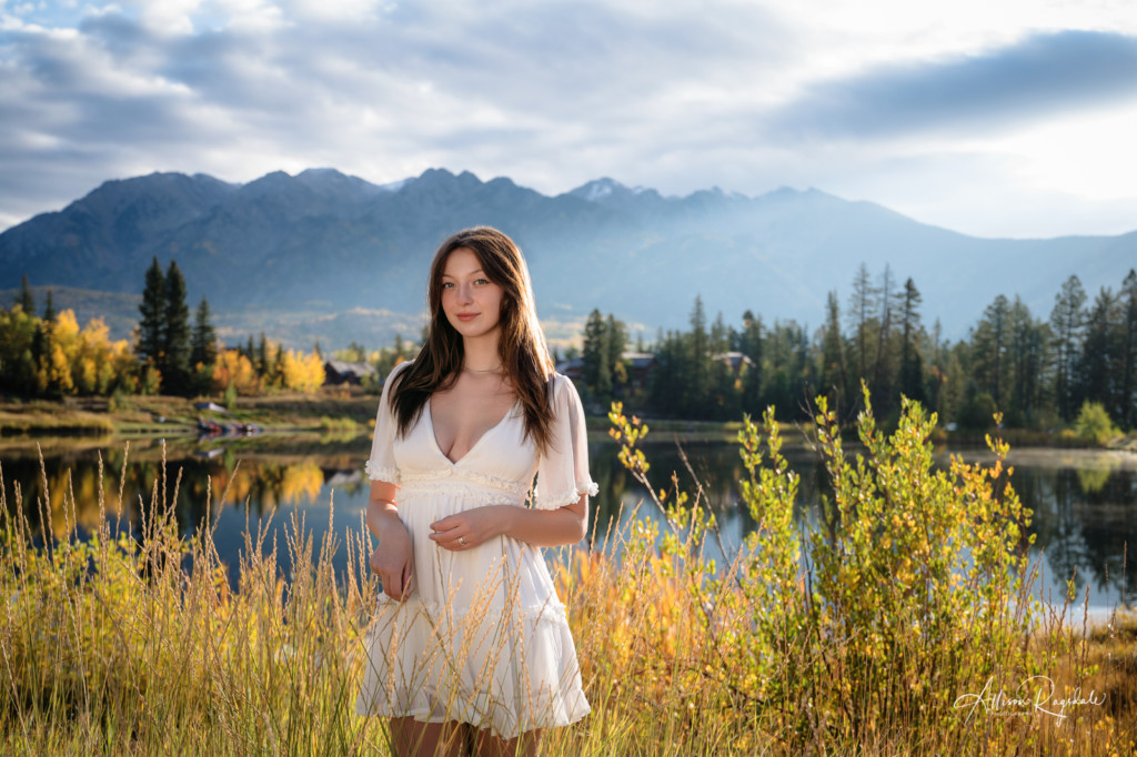 girl in white dress lake and mountain background senior photo