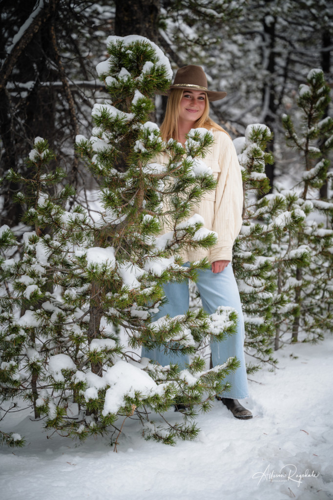 snow in pine tree branches senior girl picture