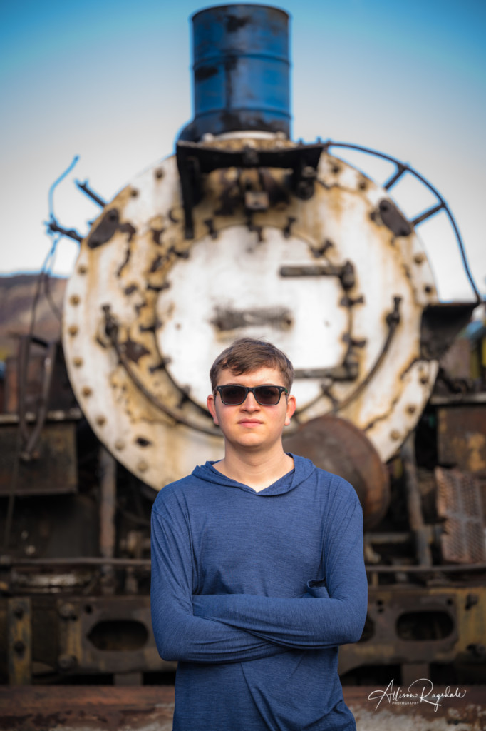 senior photo in front of old train
