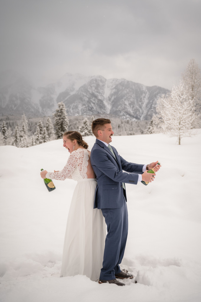 bride & groom popping champagne winter colorado elopement picture
