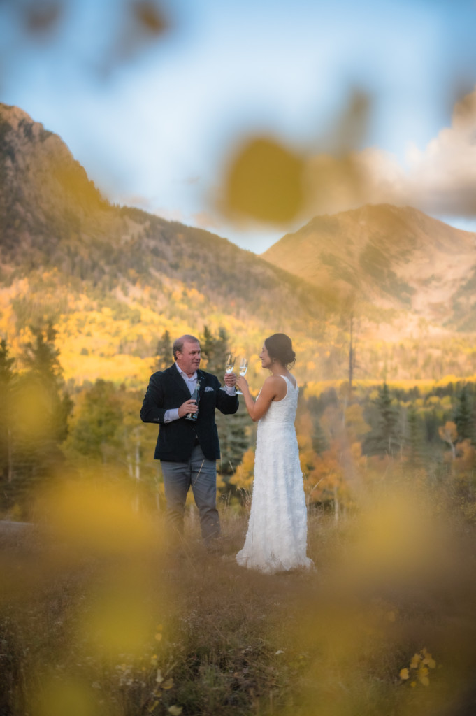 newlyweds toasting champagne fall colorado elopement portrait