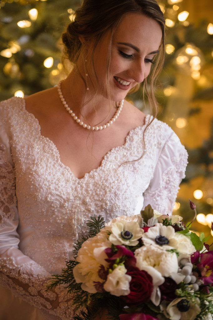 bride in front of christmas tree photo
