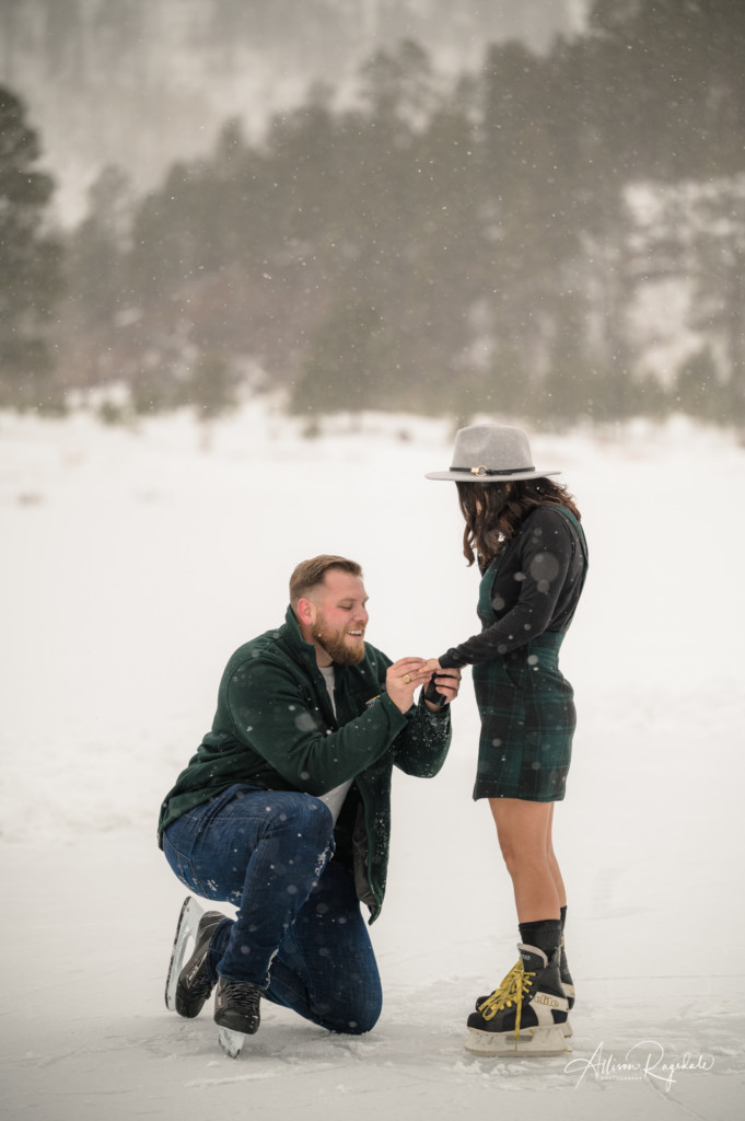 surprise proposal on ice skates putting on the ring picture