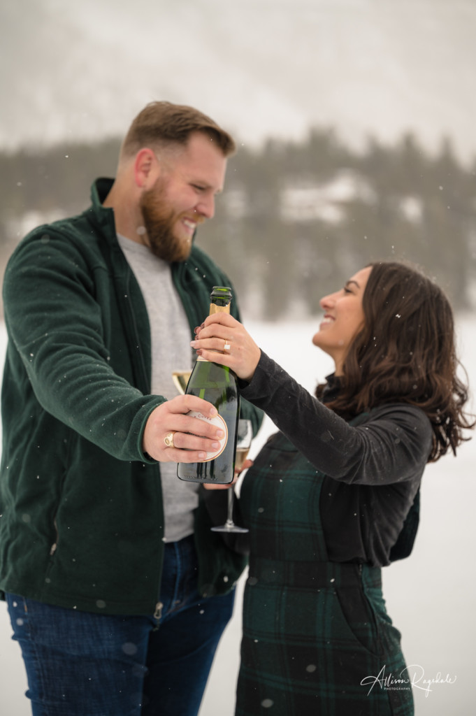 surprise proposal couple celebrating with champagne portrait