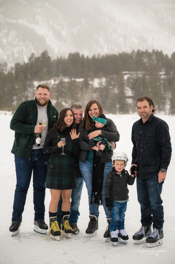 family celebrating surprise engagement on ice picture