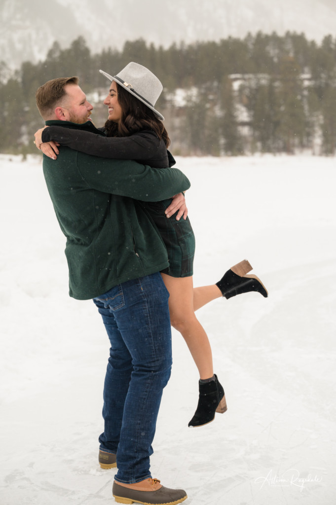 engagement session in the snow forest green portrait